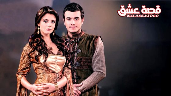Couple in Renaissance-style costumes posing together against a dark studio backdrop; woman in gold gown, man in brown vest, logo in top-right corner of the image.